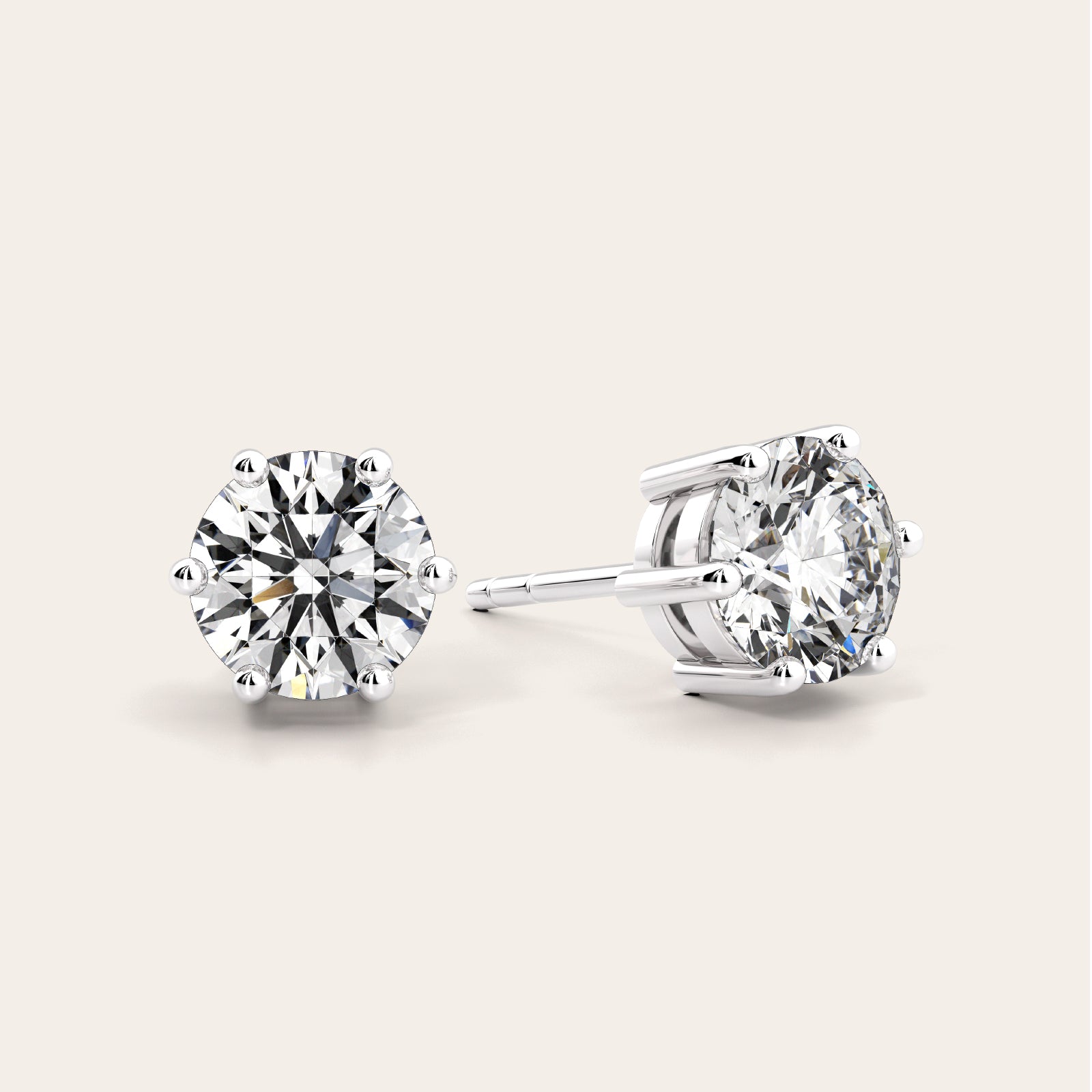 Pair of diamond stud earrings on a light gray background