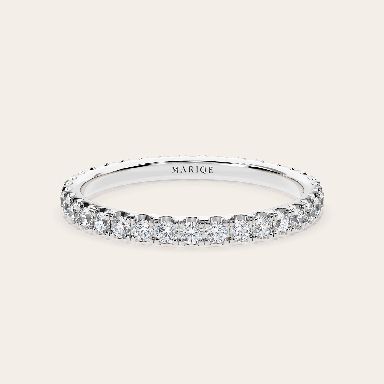 Diamond ring with 'MARIQE' branding on a white background