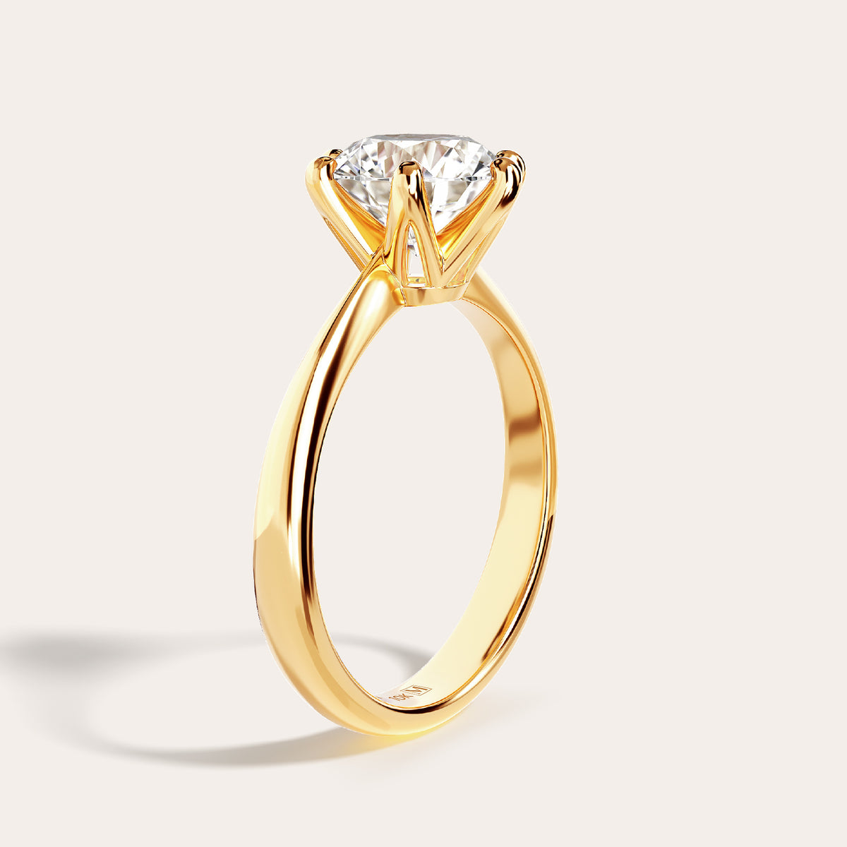 Eterna solitaire ring in 10K yellow gold, three-quarter view showing the tapered band shoulders