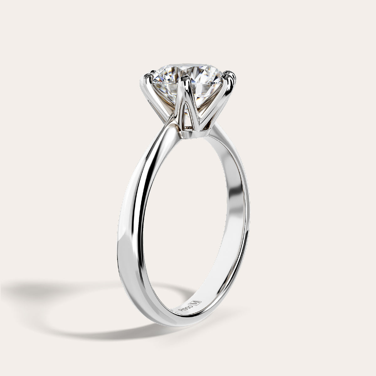 Eterna solitaire ring in platinum, three-quarter view showing the tapered band shoulders